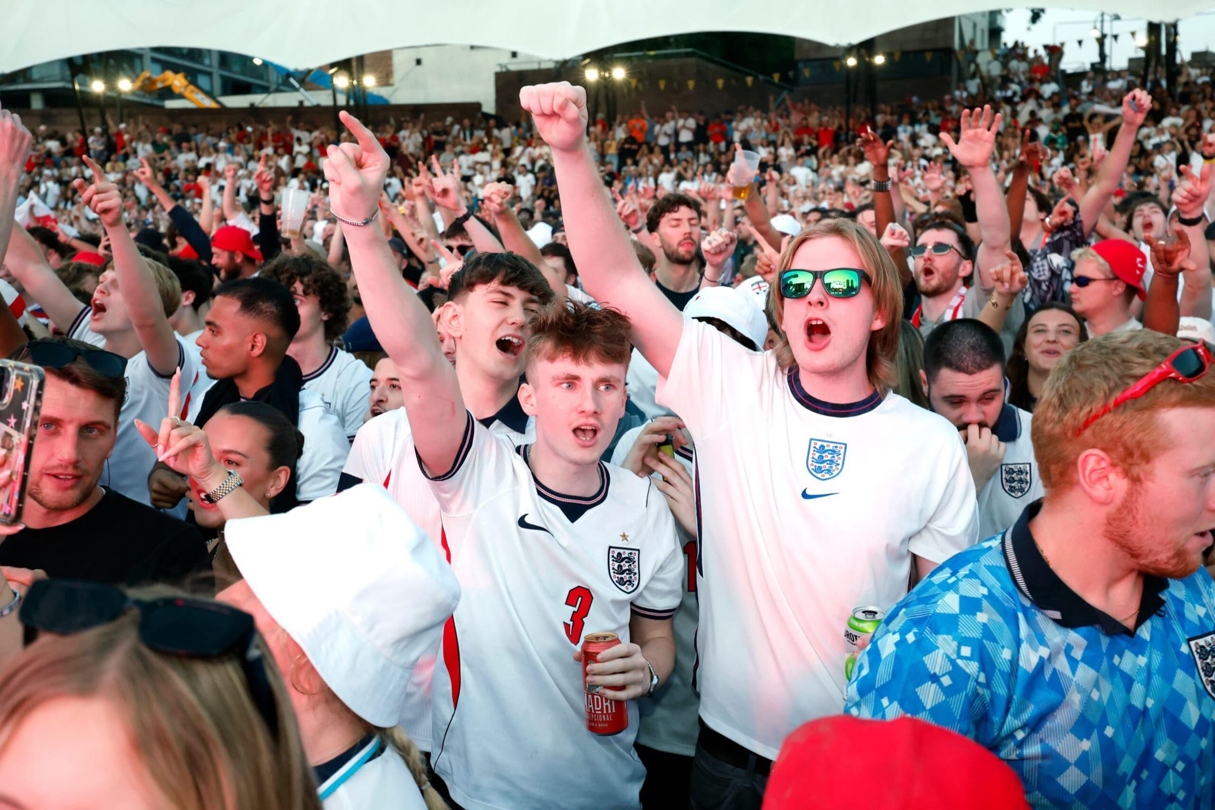 Fans celebrating together at an outdoor screening of a match